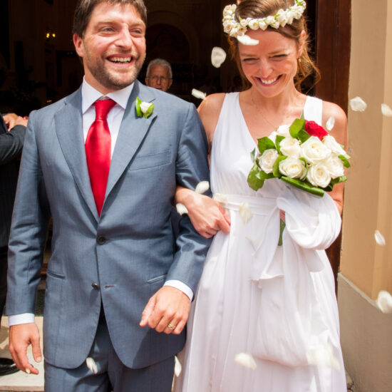 Matrimoni, sposi escono dalla chiesa sorridenti accolti da una pioggia di petali bianchi